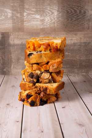 Bread with raisins and nuts on a wooden background.の写真素材