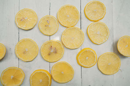 lemons with leaves on wooden backgroundの写真素材