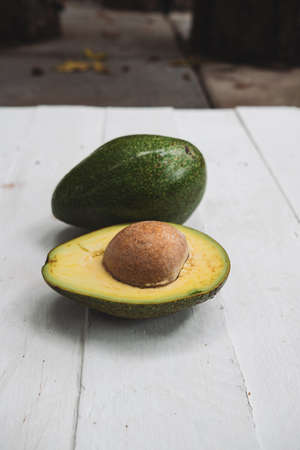 Avocados whole on  wooden  table background with copyspace