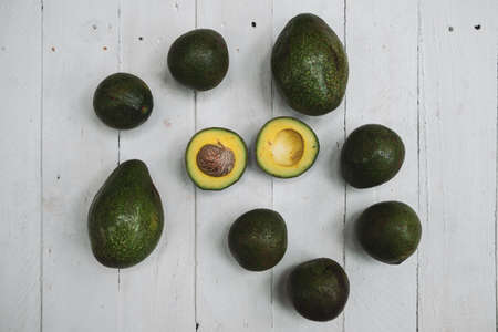 Avocados whole on  wooden  table background with copyspaceの写真素材