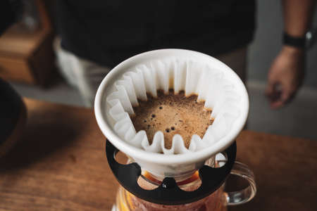 barista dripping coffee and slow coffee wooden bar style