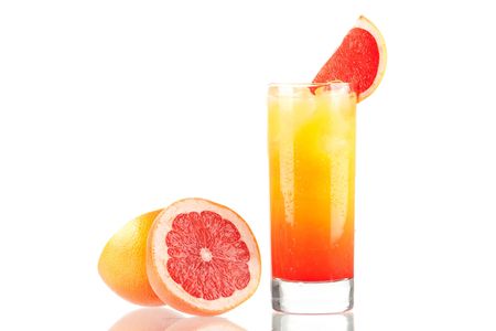 Tequila sunrise alcohol cocktail with grapefruit isolated on white backgroundの写真素材
