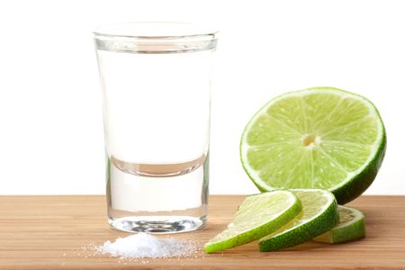 Blanc Tequila with lime and salt on wood table isolated on white backgroundの写真素材