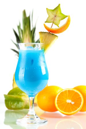 Blue Hawaii tropical cocktail with pineapple and carambola isolated on white backgroundの写真素材