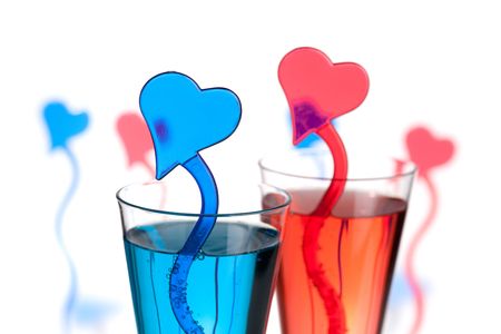 Two champagne alcohol cocktails with heart decoration. Isolated on white backgroundの写真素材