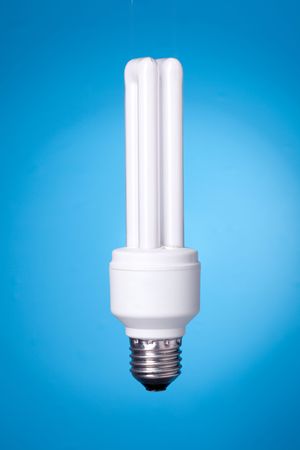 Energy saving lamp on blue gradient background