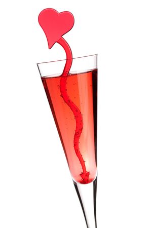 Red champagne alcohol cocktail with heart decoration. Isolated on white backgroundの写真素材