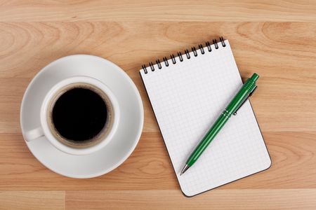 Espresso cup with blank notepad and pen on wood tableの写真素材