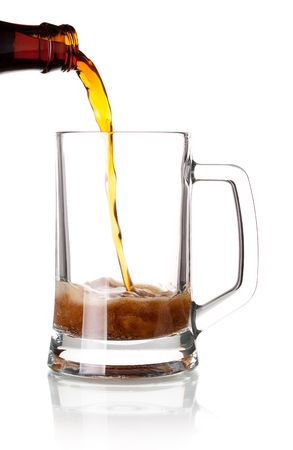 Beer collection - Beer is pouring into a glass from bottleの写真素材