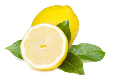 Fresh juicy yellow lemons with green leafs. Isolated on white backgroundの写真素材