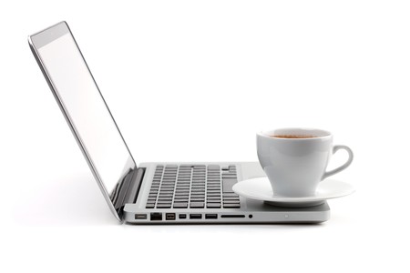 Cappuccino cup on laptop. Isolated on white backgroundの写真素材