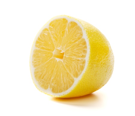 Half of ripe lemon. Isolated on whiteの写真素材