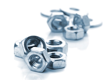 Metal nuts. Isolated on white background. Toned