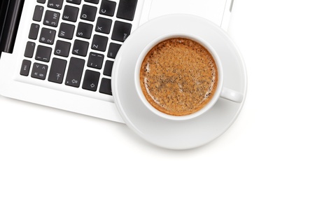 Cappuccino cup on laptop. Above view. Isolated on white backgroundの写真素材