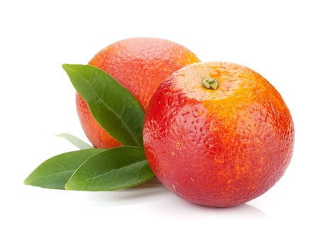 Two red oranges with leafs. Isolated on white backgroundの写真素材