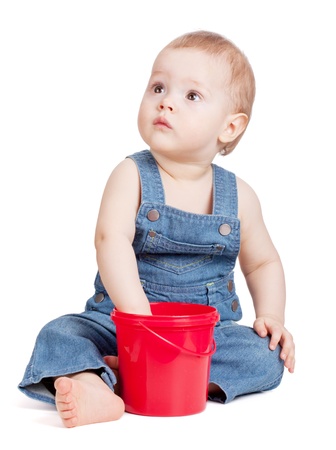 Small baby with toy bucket. Isolated on whiteの写真素材