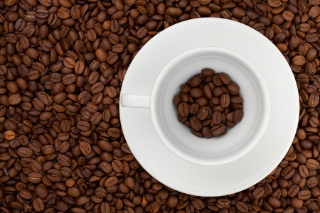 Coffee cup with beans. Above view. On beans backgroundの写真素材