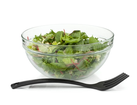 Healthy green salad with plastic fork. Above view. Isolated on white backgroundの写真素材