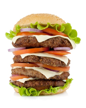 Very large burger with beef, cheese, onion and tomatoes. Isolated on white backgroundの写真素材