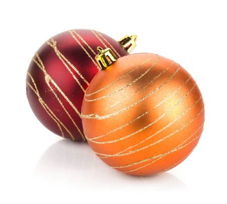 Two christmas balls: red and orange. Isolated on white backgroundの写真素材