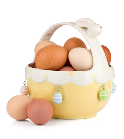 Easter eggs in basket. Isolated on white backgroundの写真素材