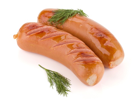Two grilled sausages with dill. Isolated on white backgroundの写真素材