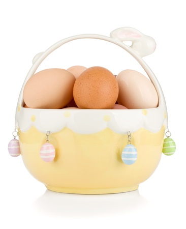 Easter eggs in basket. Isolated on white backgroundの写真素材