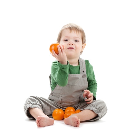 Baby with oranges. Isolated on white backgroundの写真素材