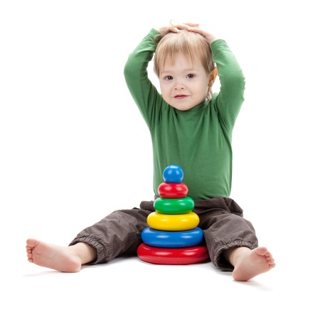 Small baby with a toy pyramid. Isolated on white backgroundの写真素材