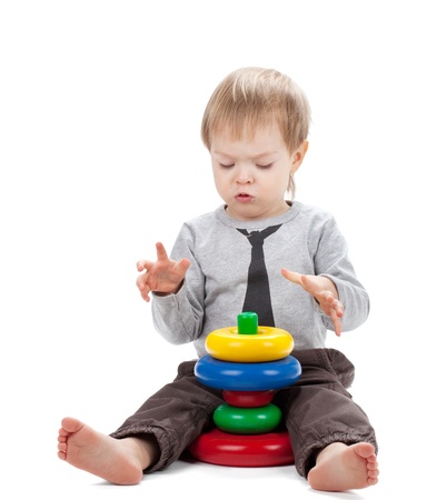 Small baby with a toy pyramid  Isolated on white backgroundの写真素材