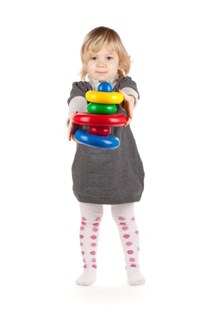 Baby girl with a toy pyramid  Isolated on white backgroundの写真素材