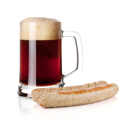 Cold dark beer in glass and two grilled sausages  Isolated on white backgroundの写真素材