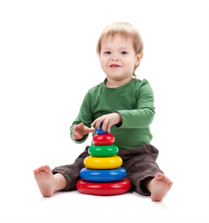 Small baby with a toy pyramid. Isolated on white backgroundの写真素材