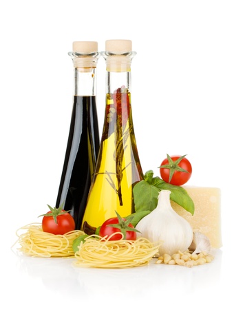 Pasta, tomatoes, basil, olive oil, vinegar, garlic and parmesan cheese. Isolated on white backgroundの写真素材