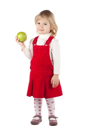 Smiling baby girl with a green apple. Isolated on white backgroundの写真素材