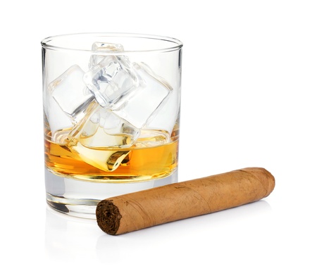 Whiskey glass and cigar. Isolated on white backgroundの写真素材