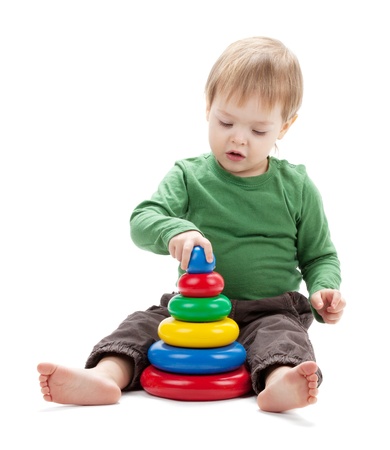 Small baby with a toy pyramid. Isolated on white backgroundの写真素材