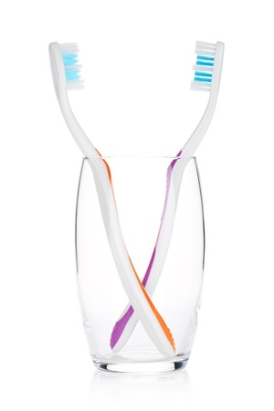 Two toothbrushes in a glass. Isolated on white backgroundの写真素材