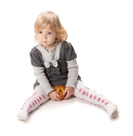 Baby girl with apple. Isolated on white backgroundの写真素材