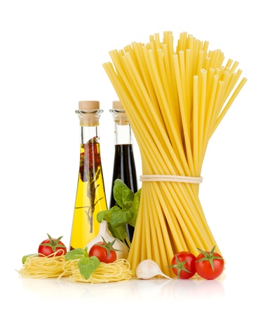 Pasta, tomatoes, basil, olive oil, vinegar, garlic and parmesan cheese. Isolated on white backgroundの写真素材