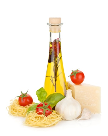 Pasta, tomatoes, basil, olive oil and parmesan cheese. Isolated on white backgroundの写真素材