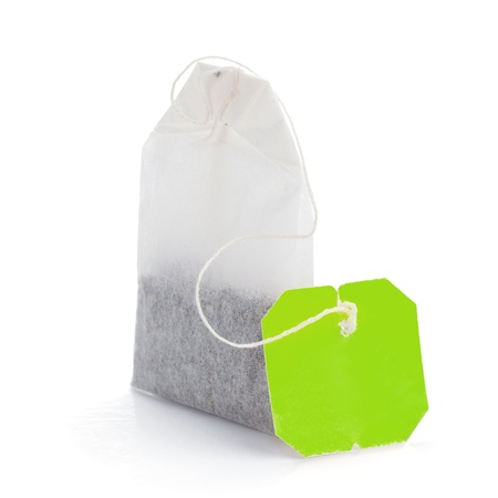 Teabag with green label. Isolated on white backgroundの写真素材