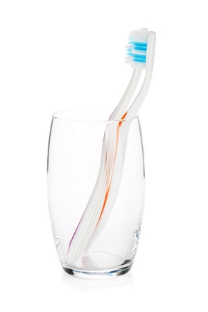 Two toothbrushes in a glass  Isolated on white backgroundの写真素材