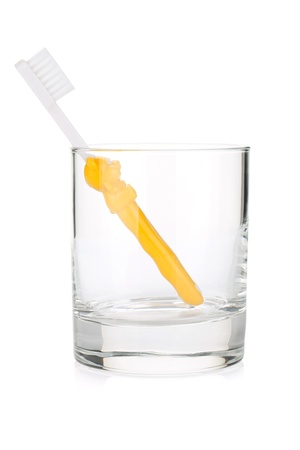 Baby toothbrush in a glass. Isolated on white backgroundの写真素材