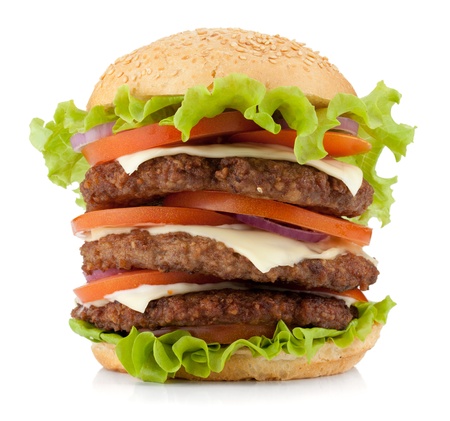 Large burger with beef, cheese, onion and tomatoes. Isolated on white backgroundの写真素材
