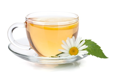 Cup of tea with lemon slice, mint leaves and chamomile flower. Isolated on white backgroundの写真素材