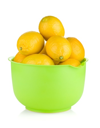 Fresh ripe lemons in a bowl. Isolated on white backgroundの写真素材