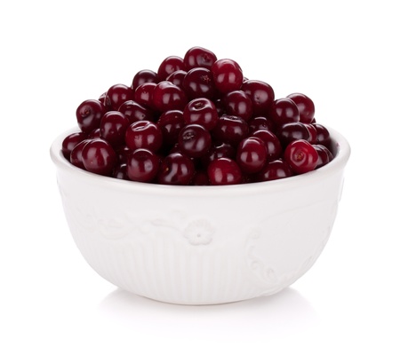 Fresh ripe cherries in bowl  Isolated on white backgroundの写真素材