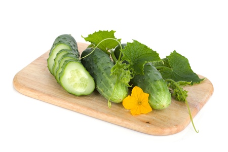 Ripe sliced cucumber on cutting board  Isolated on white backgroundの写真素材