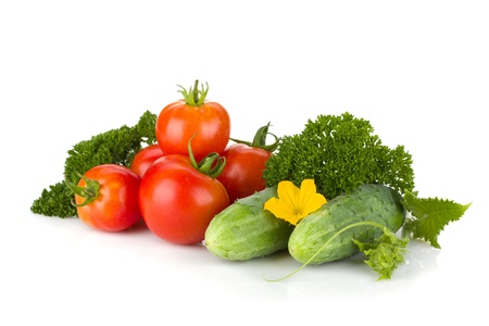 Ripe tomatoes, cucumbers and parsley. Isolated on white backgroundの写真素材